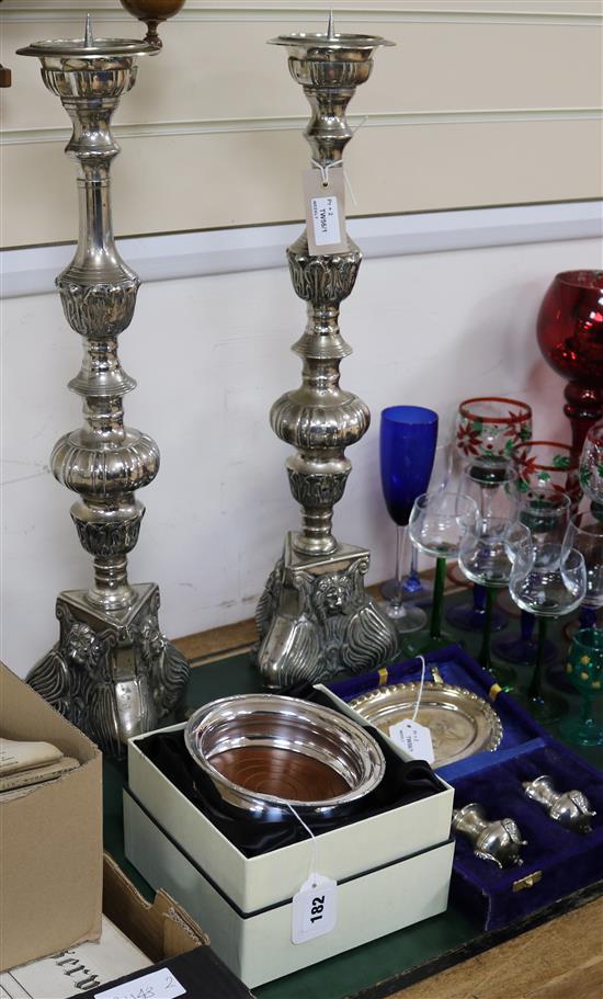 A pair of large plated pricket candlesticks, applied lion masks, an Arthur Price boxed wine coaster and a cased condiment set